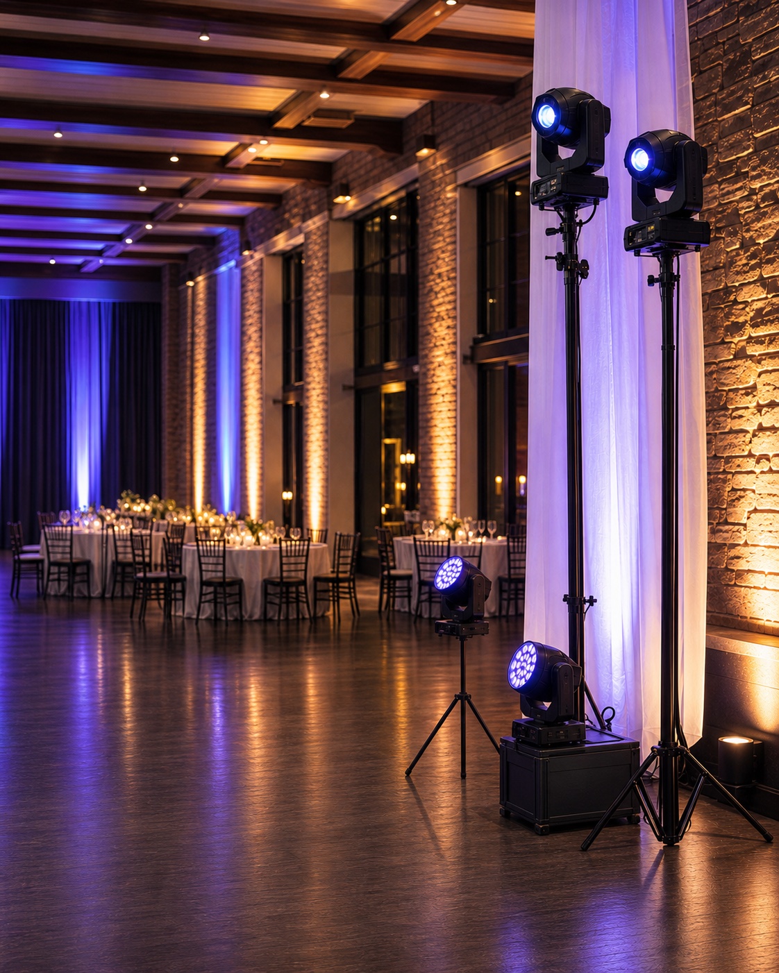 Professional event lighting with amber uplights and blue-violet accents